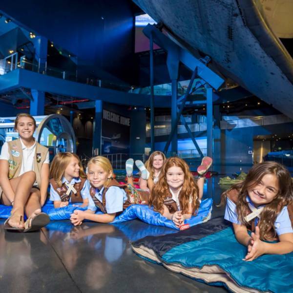 Group of girls on sleeping bags at an overnight adventure at Kennedy Space Center